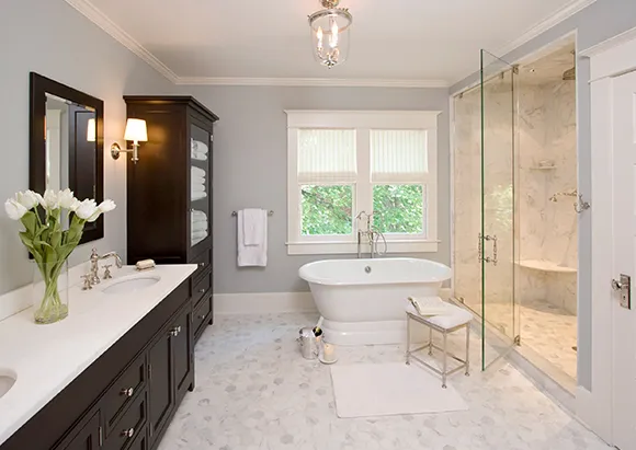 A luxurious bathroom featuring a glass-enclosed shower, marble flooring, and elegant lighting, representing professional bathroom remodeling in Minden, NV.